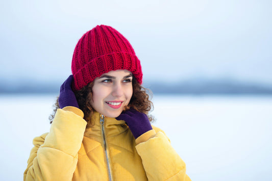A person using Arcfomor heated gloves to prevent Raynaud's symptoms during a cool spring morning walk.
