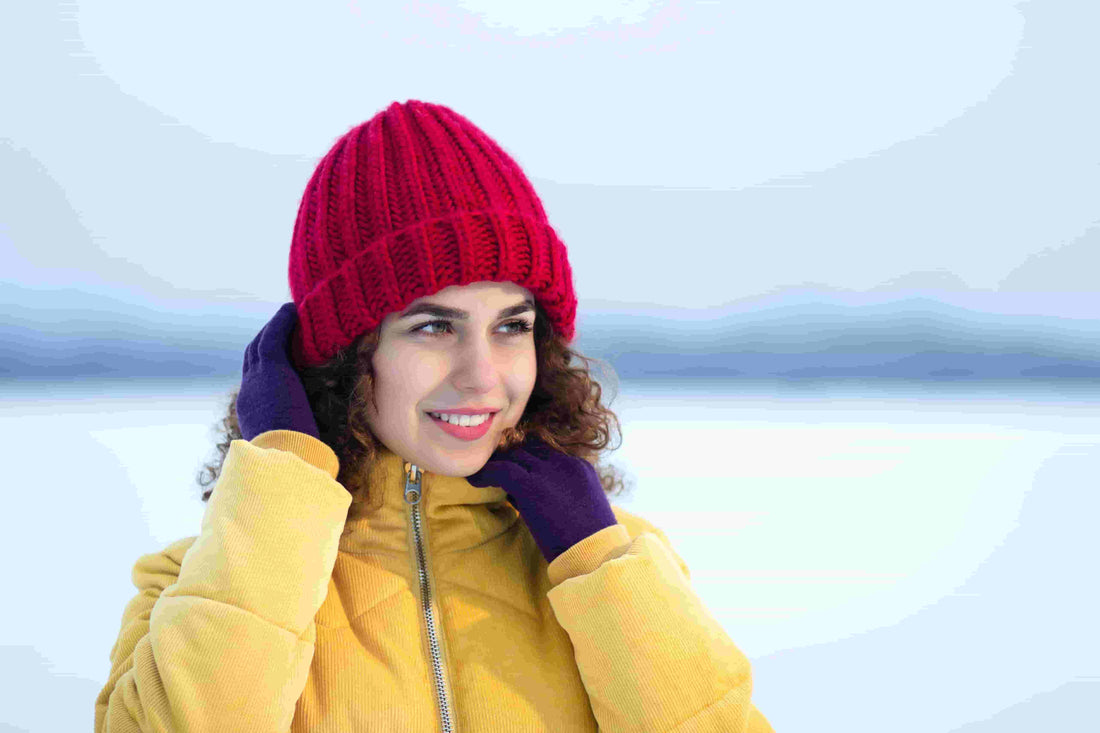 A person using Arcfomor heated gloves to prevent Raynaud's symptoms during a cool spring morning walk.