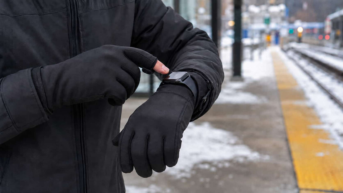 Winter commuter using an Apple Watch while wearing slim flip-top heated gloves