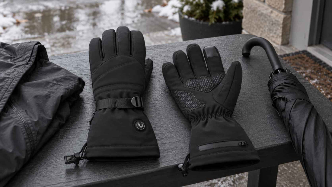 WinterGlow heated gloves beside a rain jacket and umbrella after light winter rain