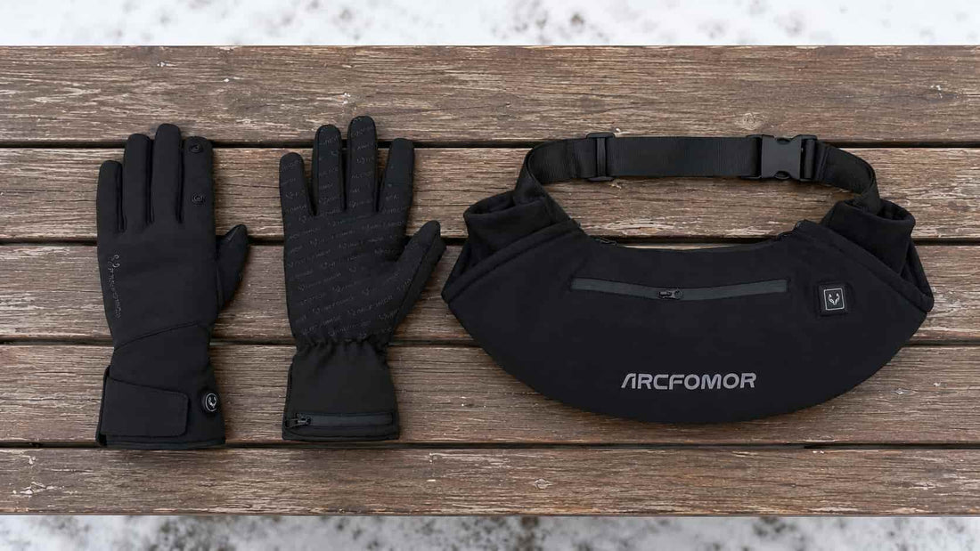 Spider Silk heated gloves and WarmHeart rechargeable heated hand-warmer muff displayed side by side at a snowy sports field