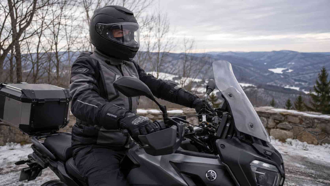 Winter rider wearing Arcfomor Basalt heated motorcycle gloves while holding touring motorcycle handlebars