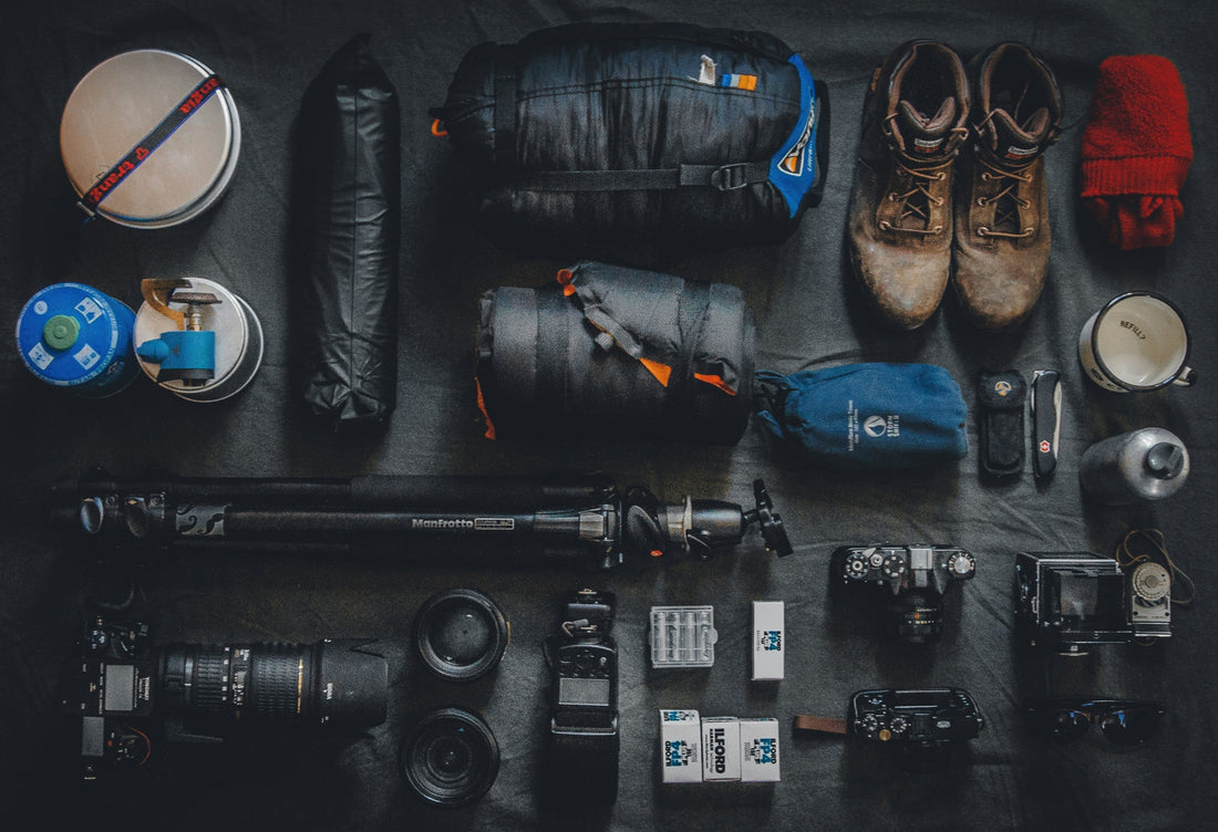 A winter gear audit checklist on a sunny garage workbench next to emergency tools and premium gloves, illustrating off-season home emergency prep.