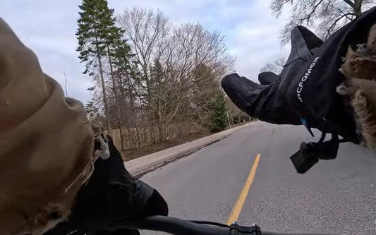 Cyclist wearing Arcfomor Ottawa Nights heated gloves during a cold-weather road ride