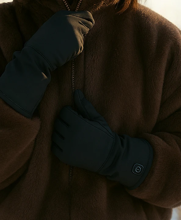 A man wears Yellowstone Gentleman's Shell Gloves in cold weather along with Dragonfly Lined Heated Gloves.