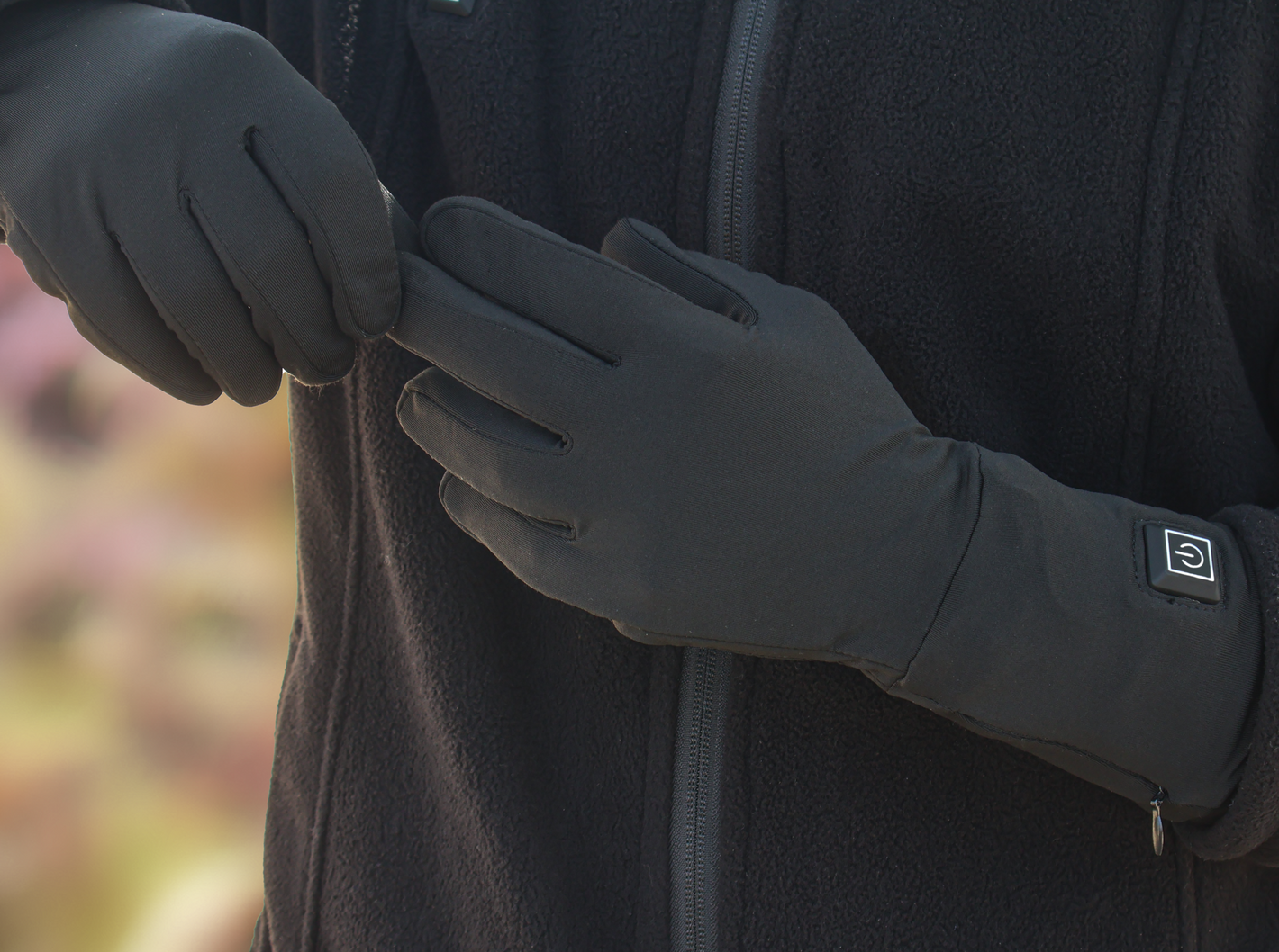 A man wears dragonfly-lined heated gloves to ward off the cold.
