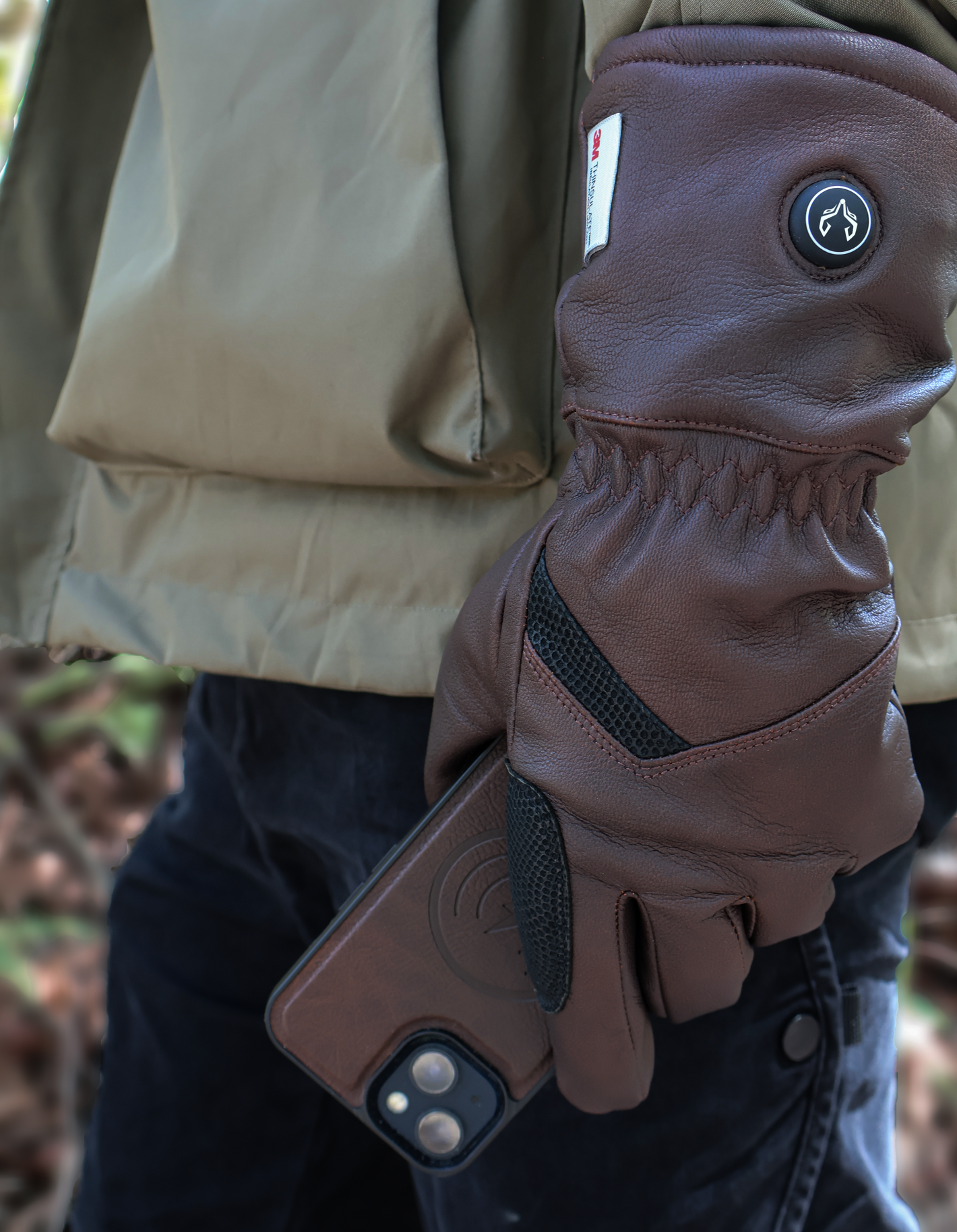 A man in the field wearing Vellum heated gloves.