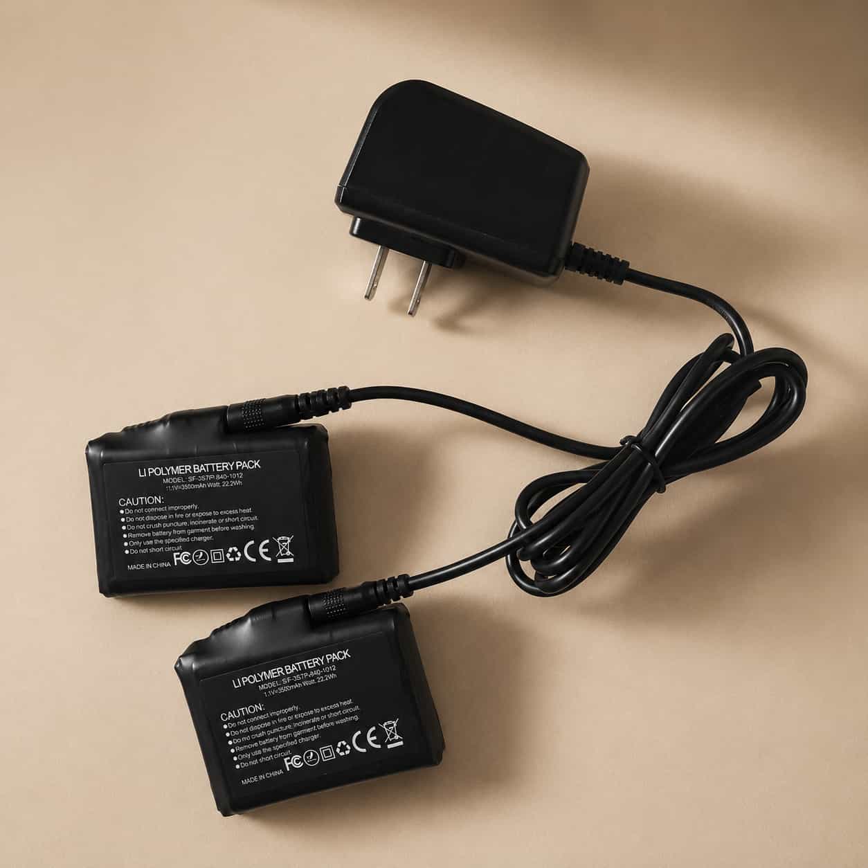 Arcfomor dual-port charger connected to two 7.4V heated glove batteries
