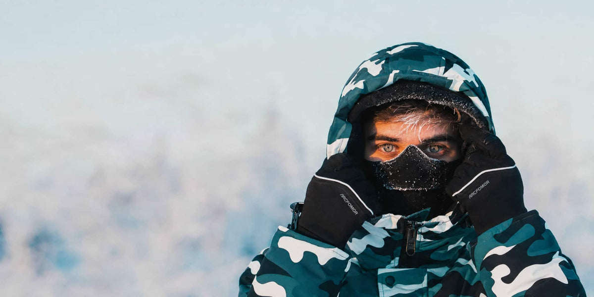 Man wearing Arcfomor heated gloves outdoors in cold winter weather