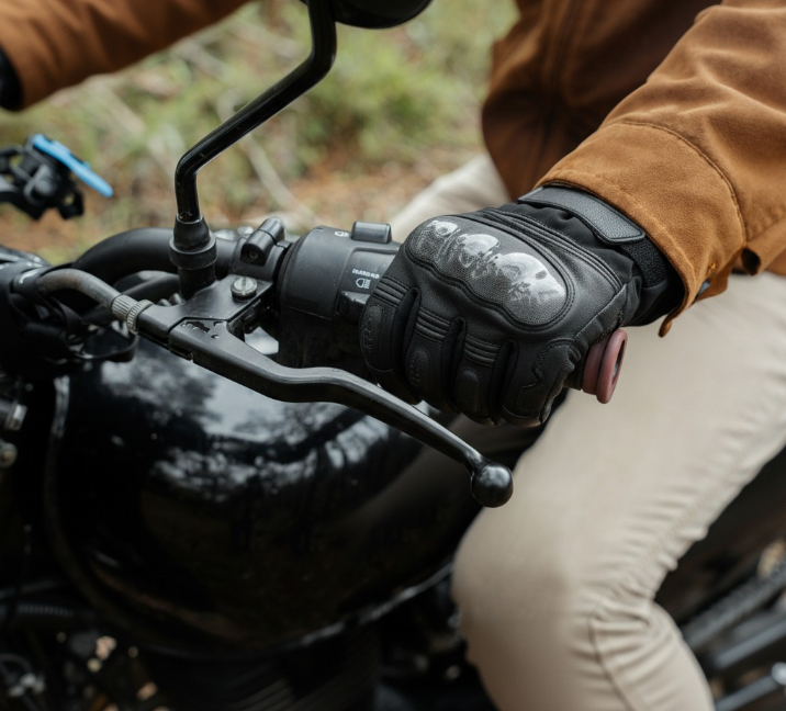 Rider wearing black Basalt heated motorcycle gloves on a street motorcycle in cold weather