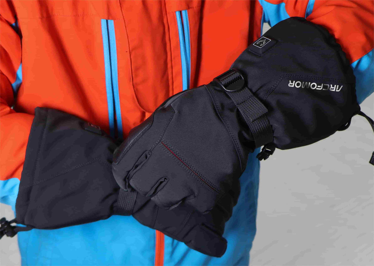 Skier wearing Crab Leg five-finger heated snow gloves with winter outerwear