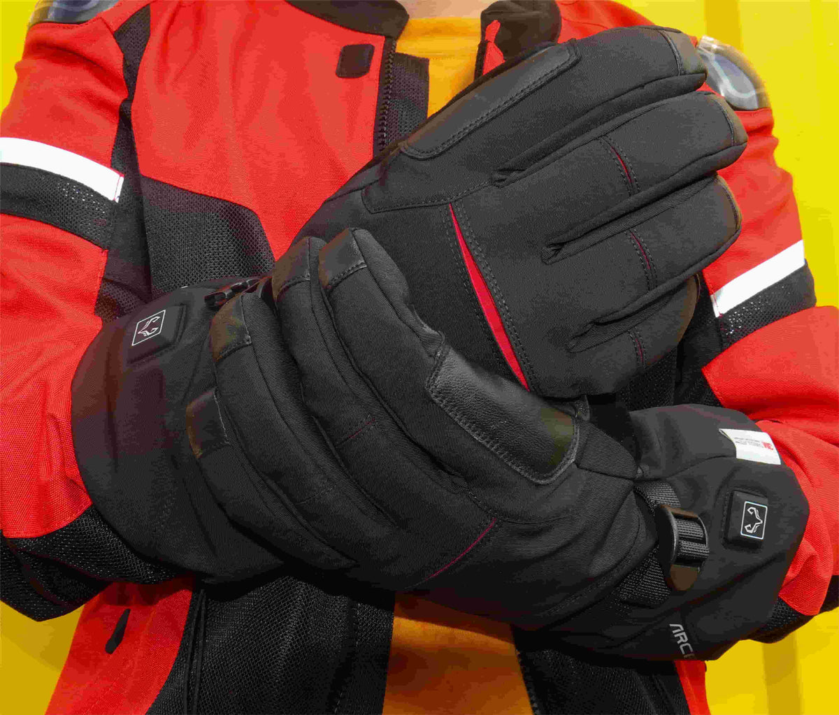 Rider showing the back and goatskin palm of Crab Leg heated gloves before a cold-weather ride