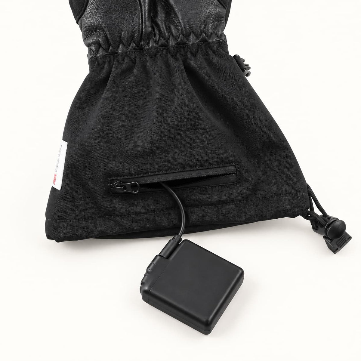 Crab Leg glove cuff with an open zippered battery pocket, connected battery and drawcord adjustment.