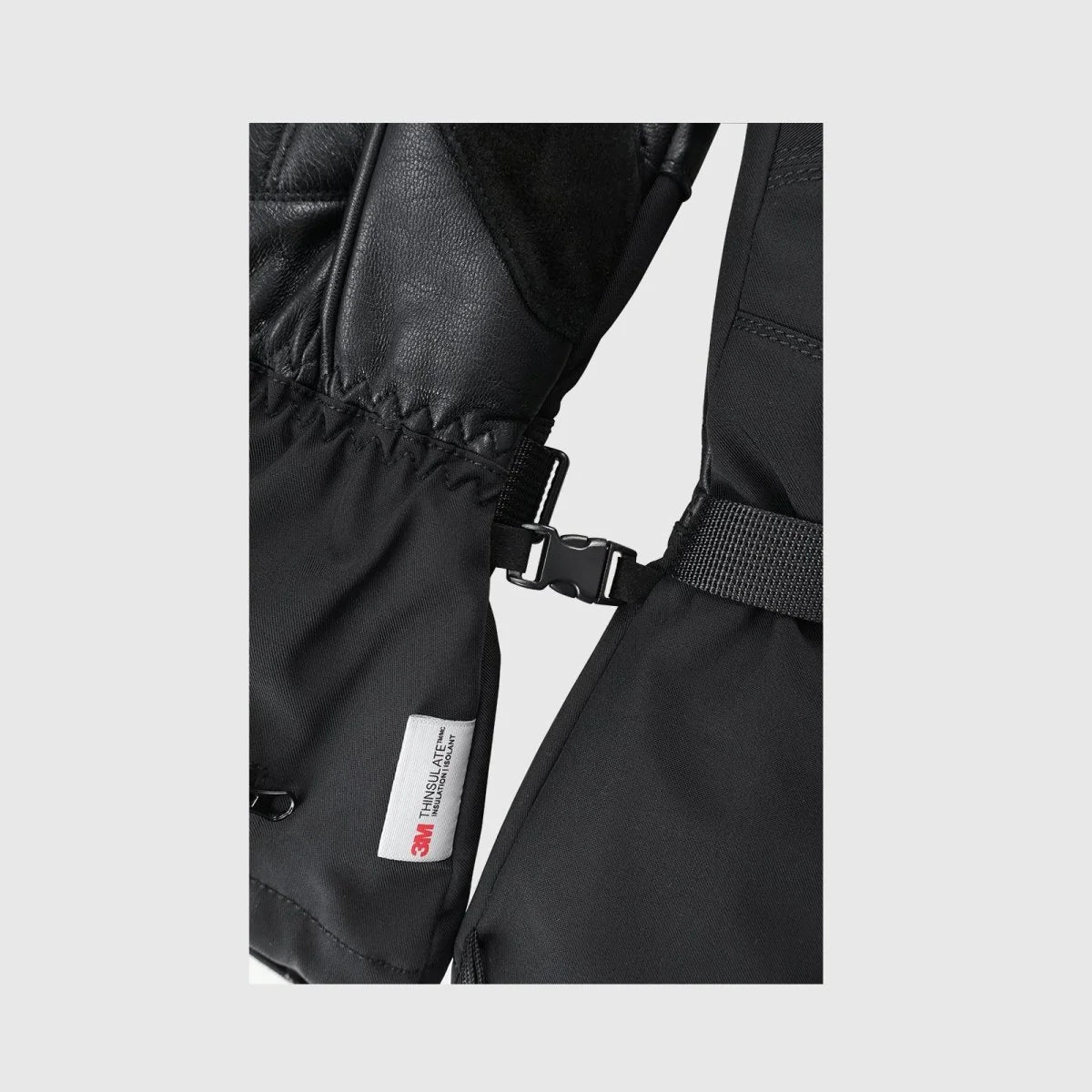 Crab Leg heated snow gloves showing the pairing clip, wrist strap and 3M insulation label