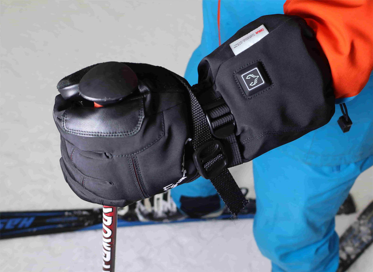 Skier gripping a ski pole while wearing Crab Leg heated snow gloves