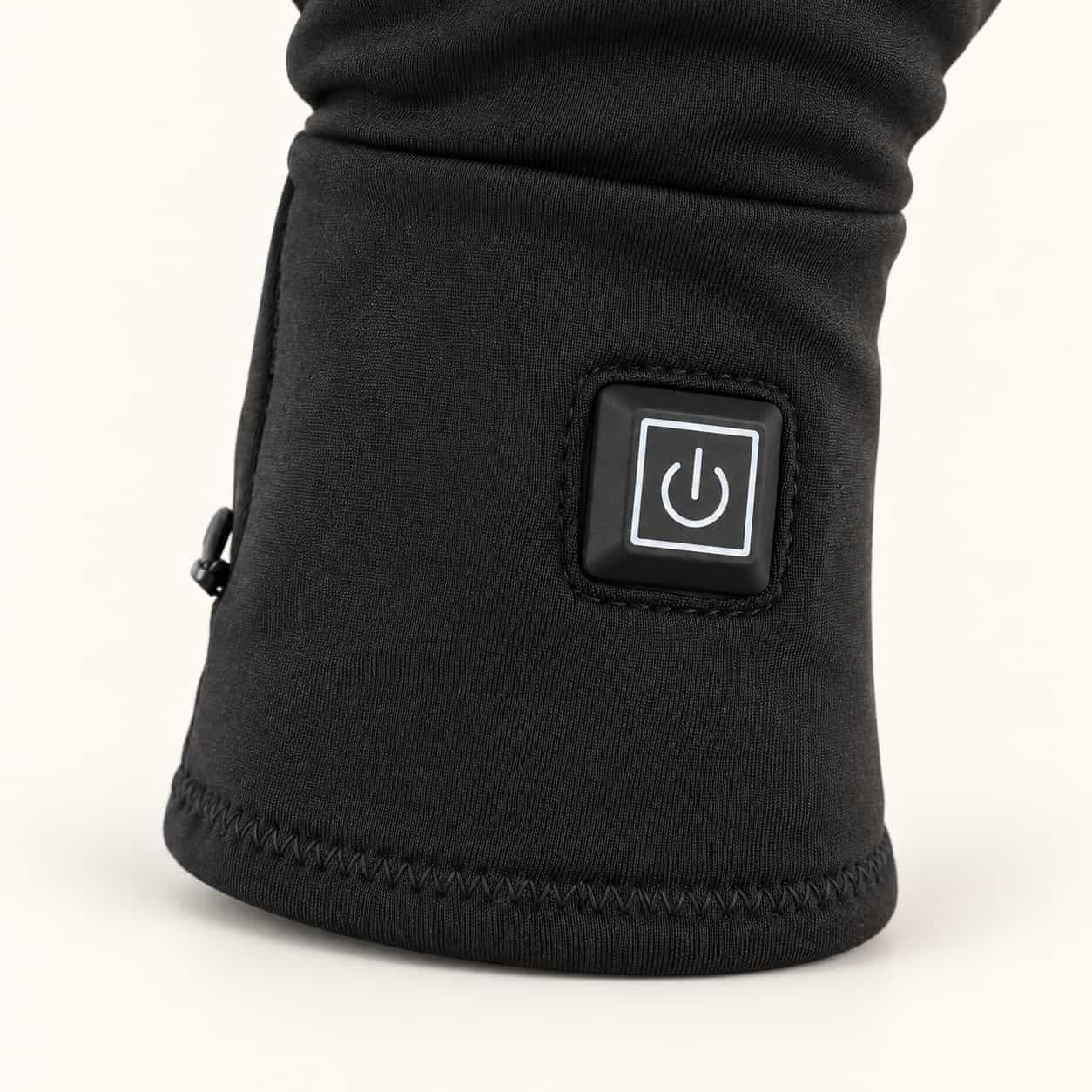 Square heat control button and stitched cuff on a Dragonfly heated glove liner.
