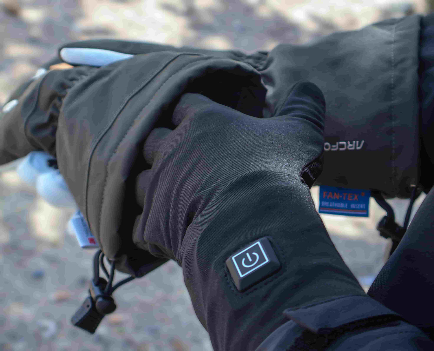 Dragonfly heated glove liner worn beneath a roomy winter outer glove