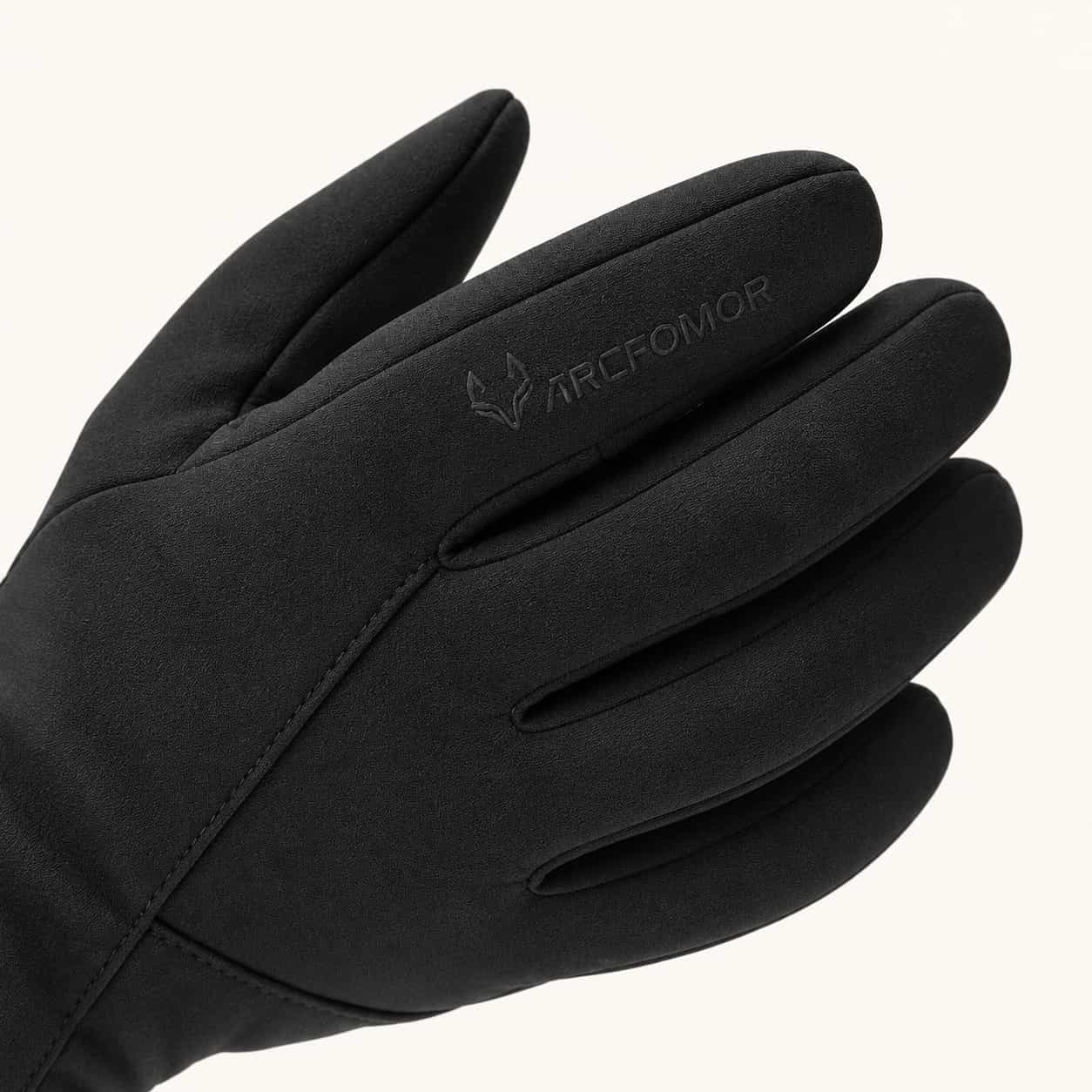 Close-up of an Ember 2.0 glove showing black fabric, finger seams and a tonal ARCFOMOR logo.