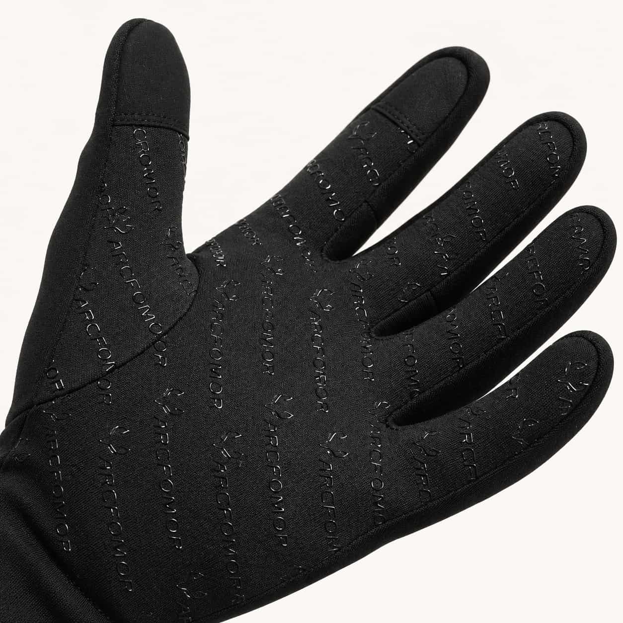 Palm of a Feather heated glove showing the patterned silicone grip and touchscreen pads on the thumb and index finger.