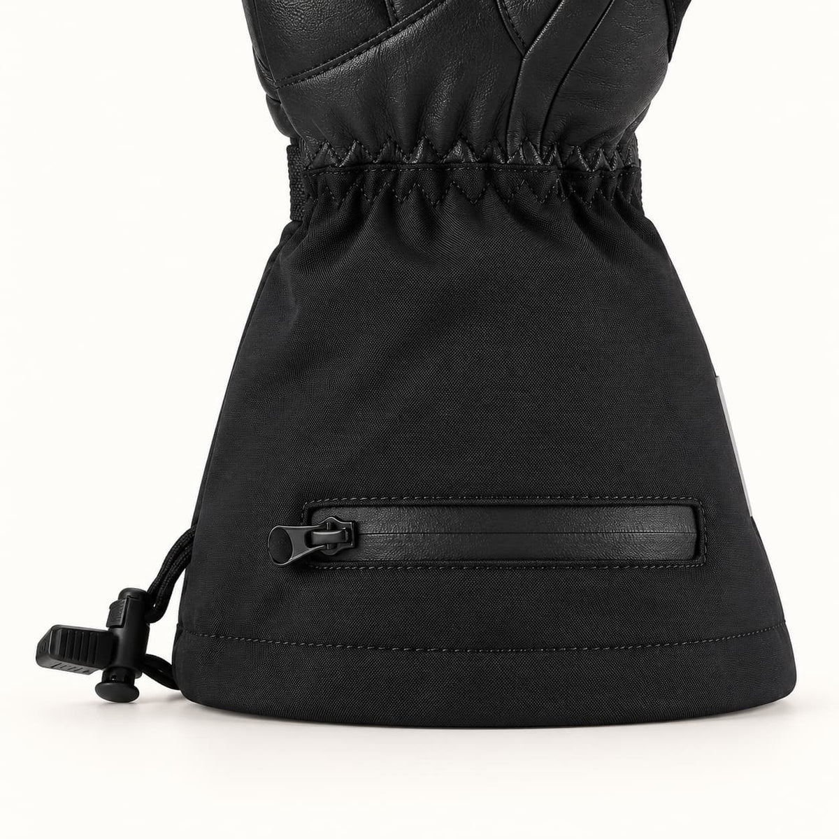 Helm glove cuff showing the horizontal battery-pocket zipper, stitched hem and adjustable drawcord with black toggles.