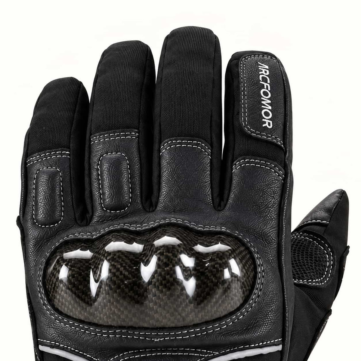 Close-up of the carbon-fiber knuckle shell, stitched leather finger panels and black woven fabric on an Onyx glove.