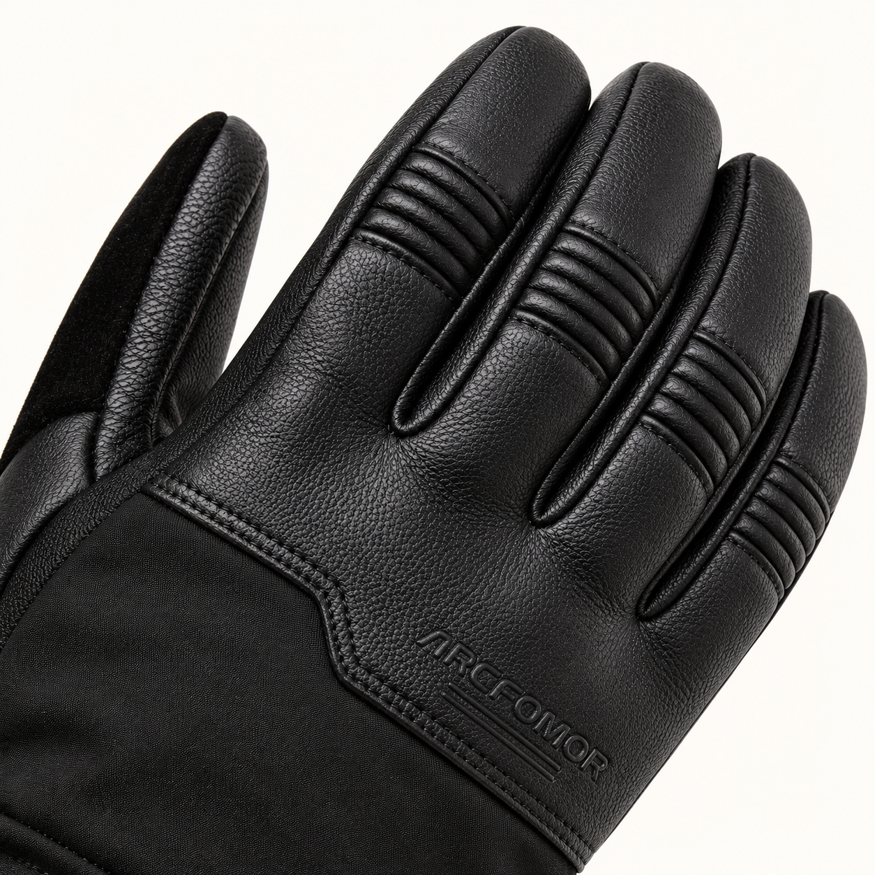 Close-up of Ottawa Nights goatskin leather showing finger-joint pleats, stitching and an embossed ARCFOMOR logo.