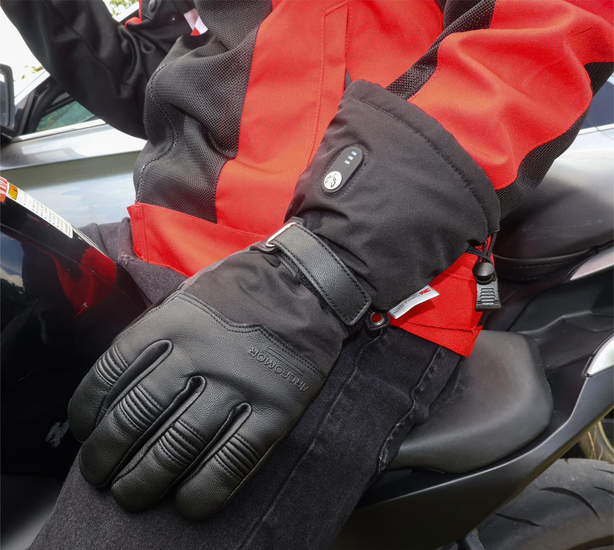 Close-up of an Ottawa Nights heated glove worn by a motorcycle rider