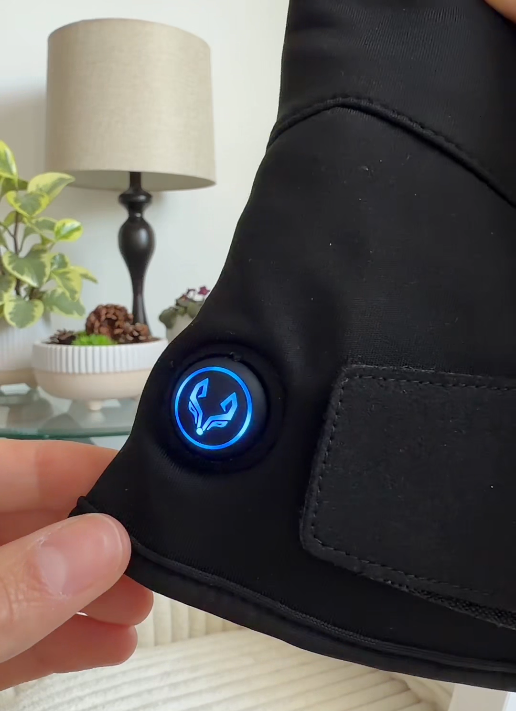 Spider Silk heated glove with the blue heat-control indicator illuminated