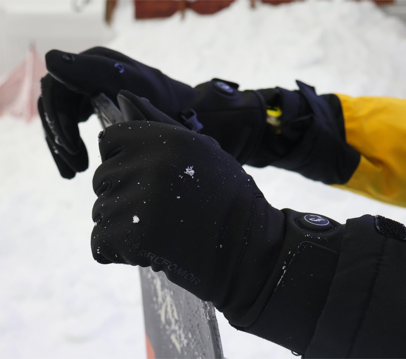 Close-up of Spider Silk heated gloves being used outdoors in snow