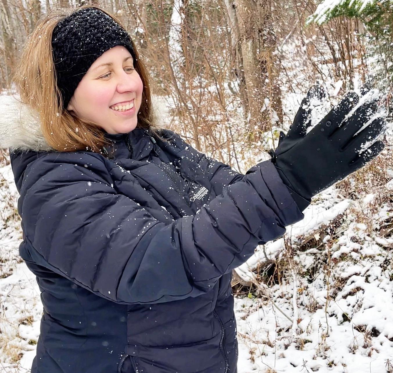 Woman wearing Spider Silk heated gloves outdoors in falling snow