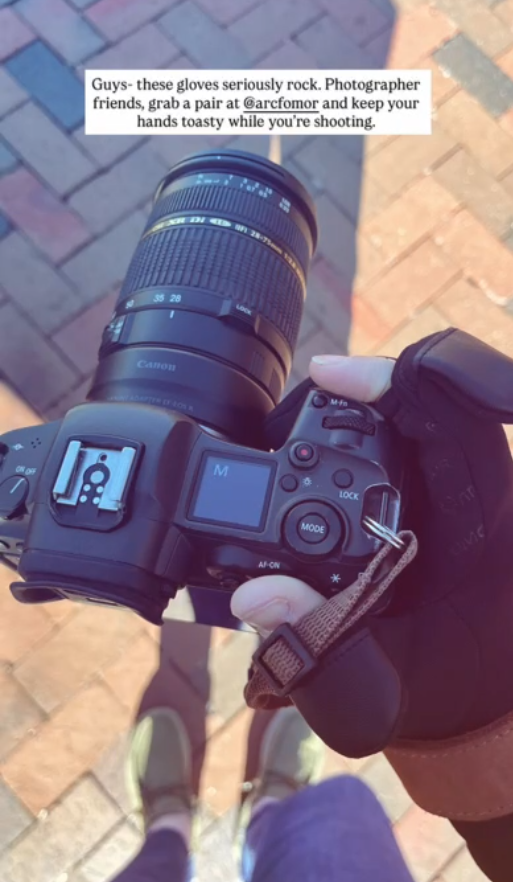 Photographer using camera controls while wearing Spider Silk flip-top heated gloves