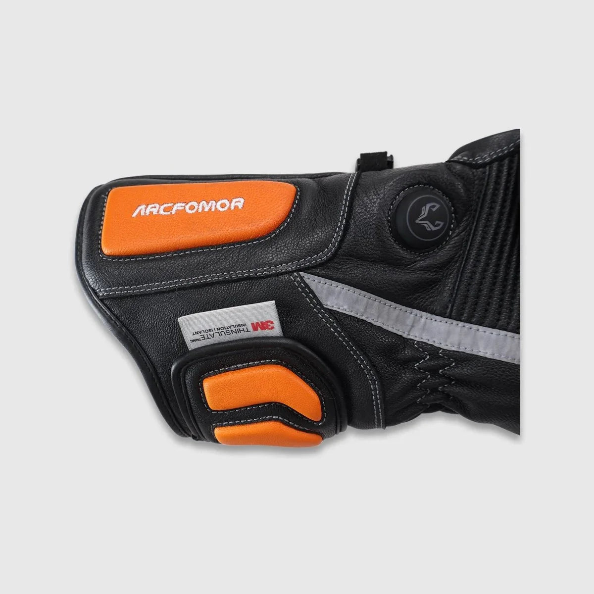 Heat control button, orange accents and reflective strip on a Tempest heated motorcycle glove