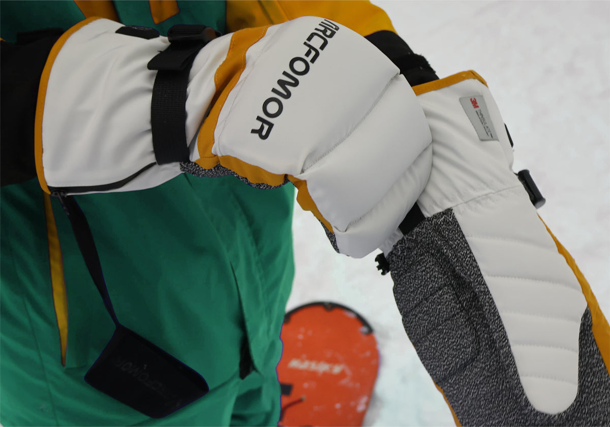 Snowboarder wearing Toboggan heated mittens with a wrist leash visible