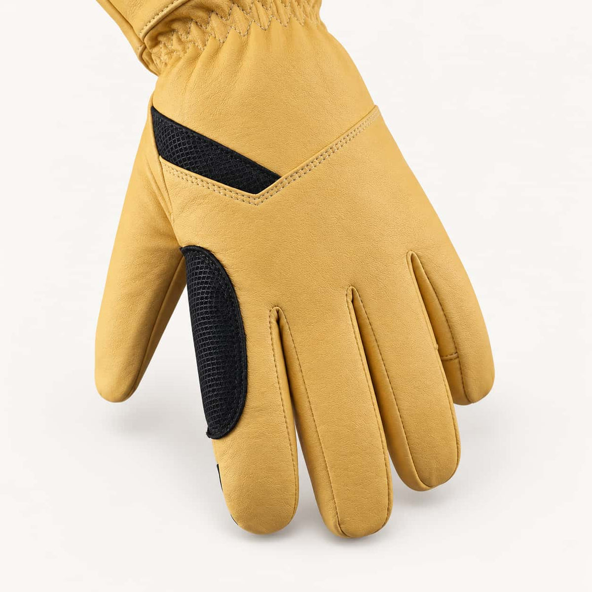 Back of a yellow Vellum 2.0 glove showing goatskin texture, double stitching and black reinforcement panels.