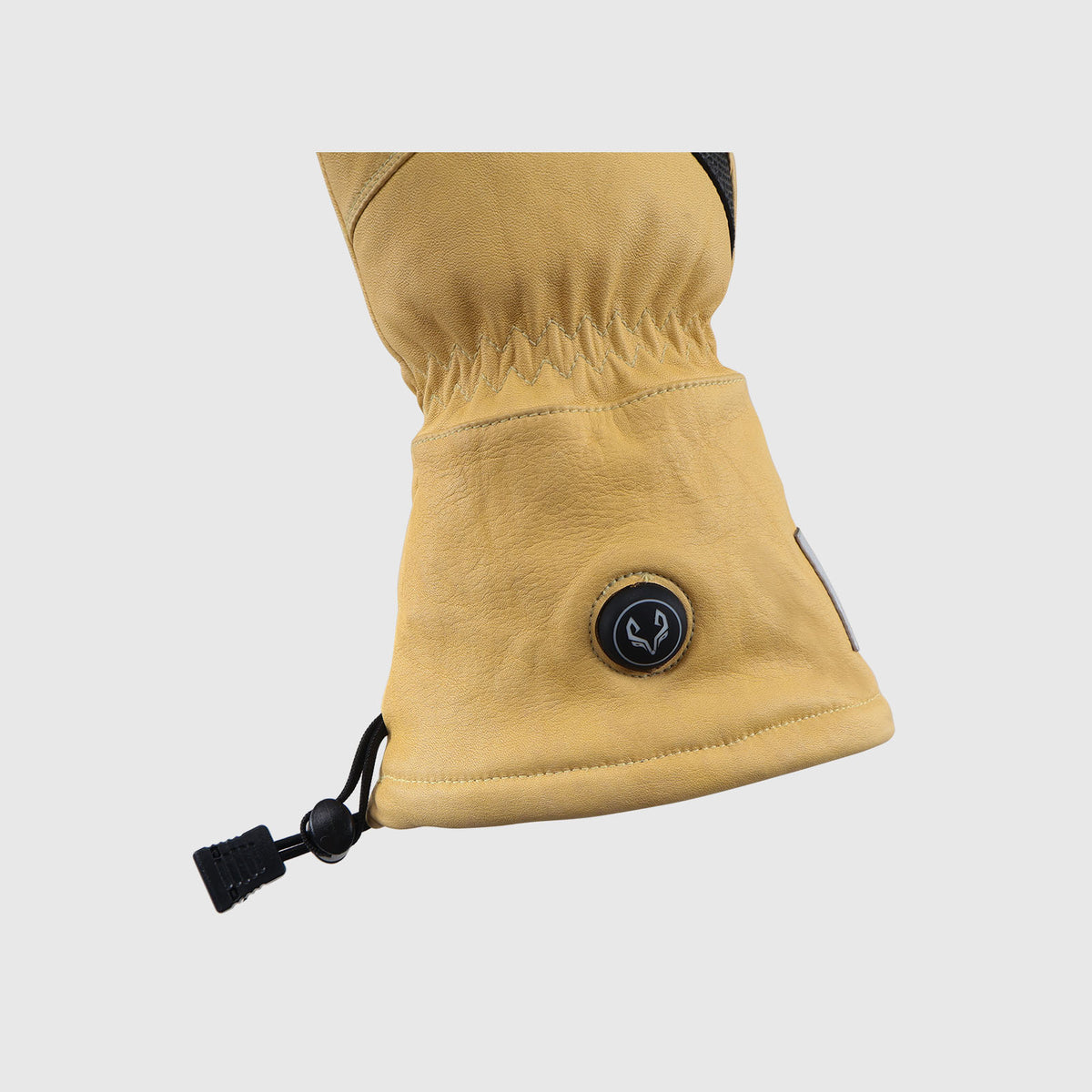 Heat control button and wrist cuff detail on a yellow Vellum 2.0 heated glove