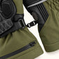 Close-up of the pairing clip joining two Vortex gloves, with olive fabric cuffs and black leather wrist panels.