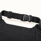 Close-up of the WarmHeart muff’s woven waist belt, showing its side-release buckle, adjustment slider and stitched attachment.