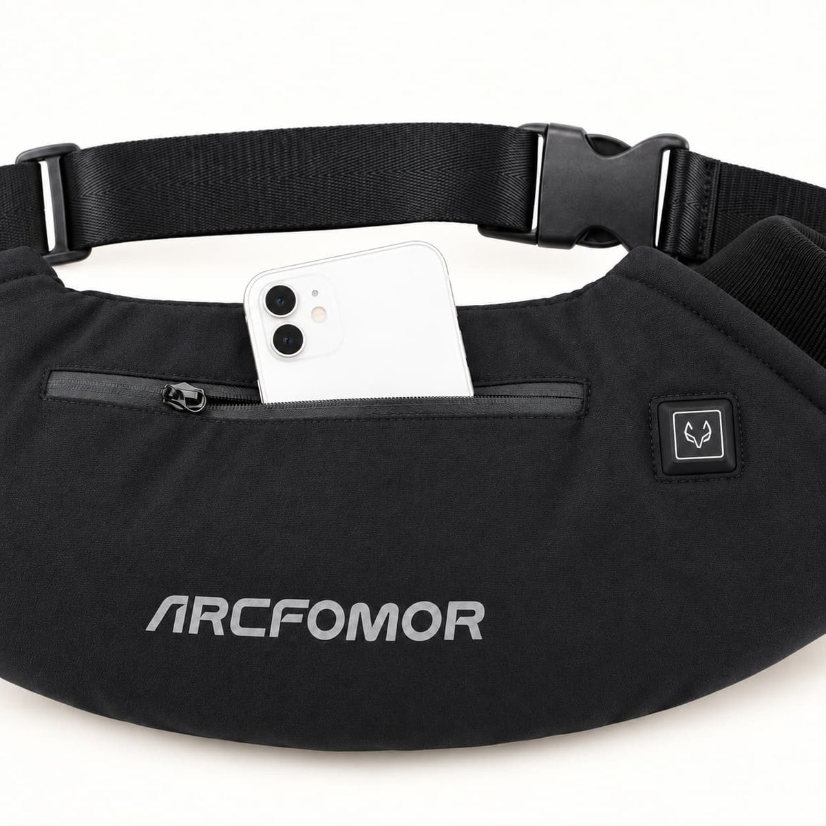 White smartphone partly inserted in the WarmHeart muff’s front zip pocket, beside the square fox-symbol heat control.