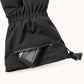 A rechargeable battery partially exposed through the WinterGlow glove’s zippered cuff pocket.