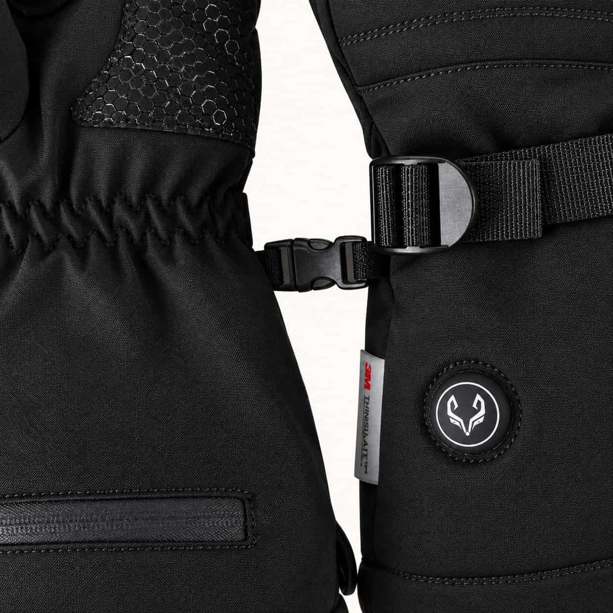 WinterGlow glove cuffs joined by a small pairing clip, with the wrist strap and heat control button visible.