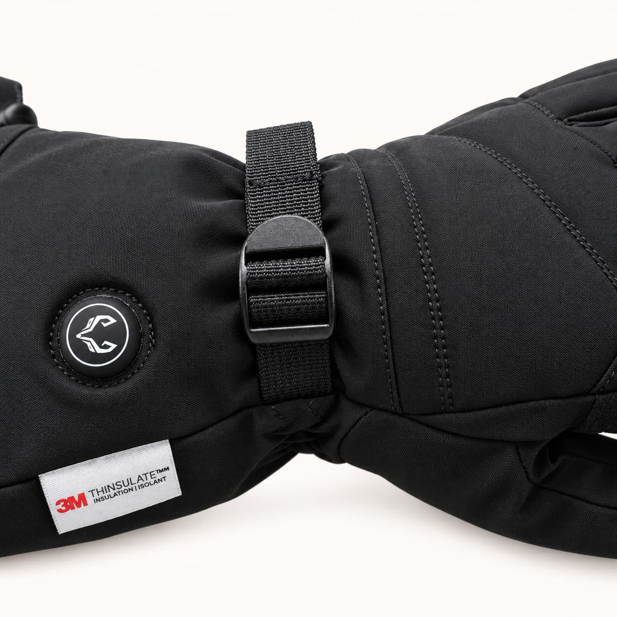 WinterGlow wrist strap, adjustment buckle, round heat control button and 3M Thinsulate label.