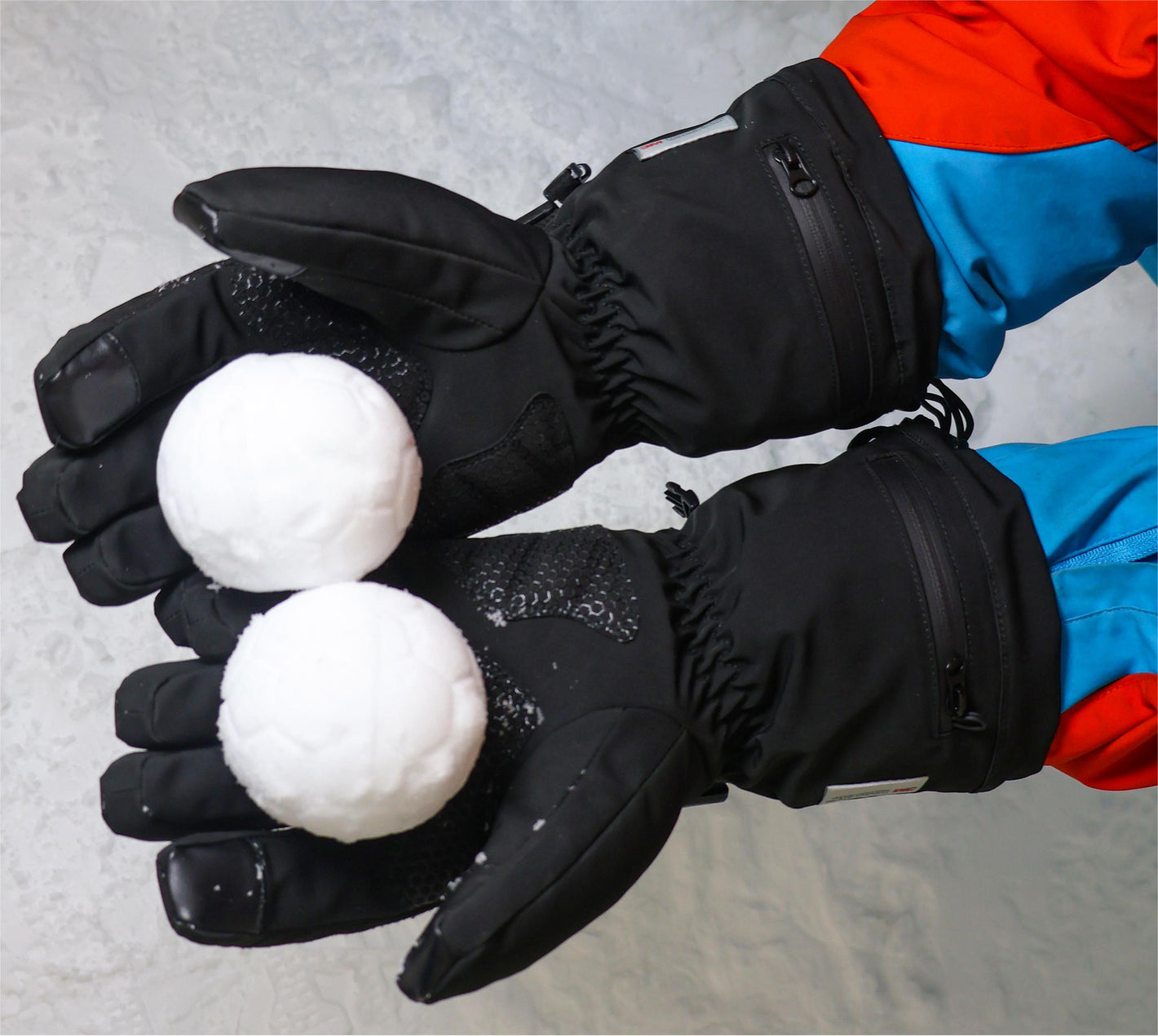 WinterGlow waterproof gloves holding snowballs with the reinforced palms visible