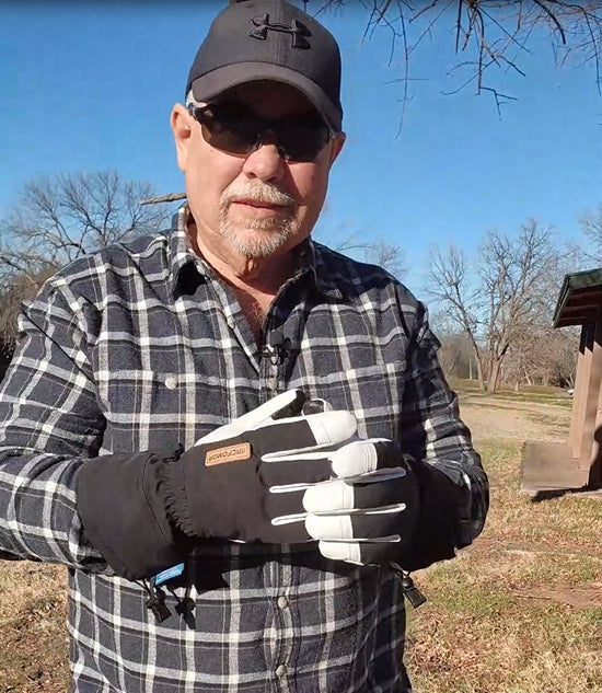 Person wearing army-green Yellowstone shell gloves outdoors