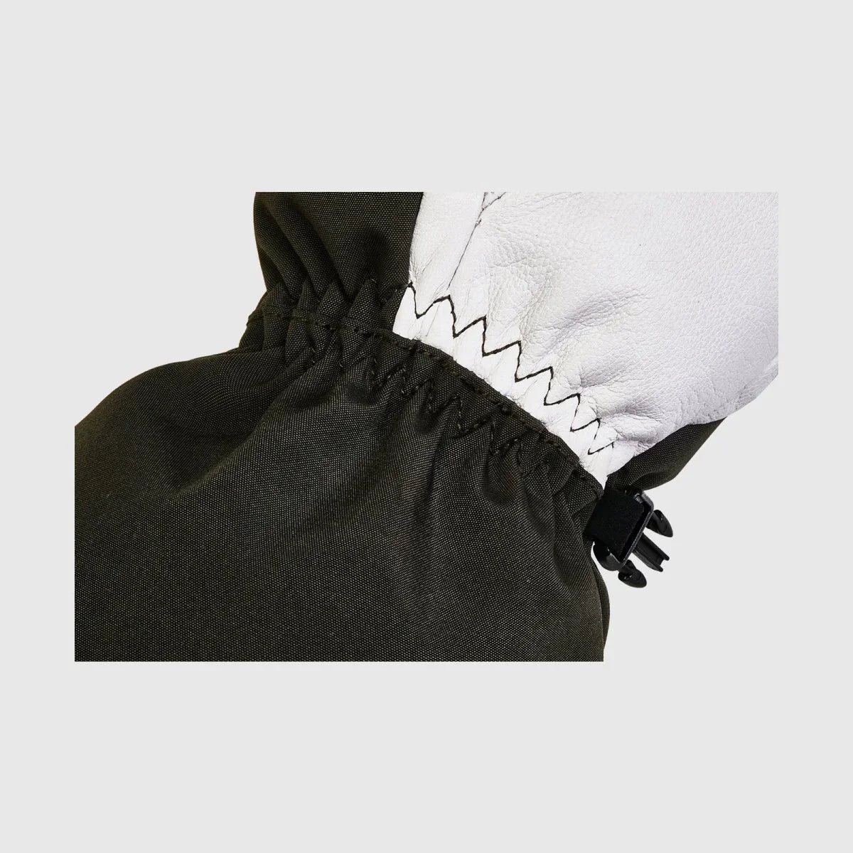 Close-up of the elastic wrist and goatskin-to-polyester construction on an army-green Yellowstone shell glove