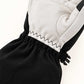 Close-up of the zigzag seam joining the white goatskin palm to the black elastic wrist on a Yellowstone glove.